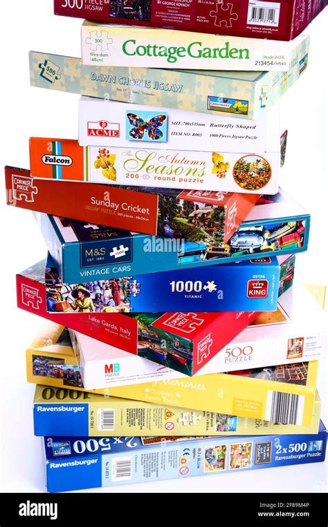 Stack of jigsaw puzzle boxes waiting to be solved Stock Photo - Alamy