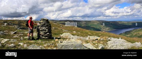 Walker at the cairns on Artle crag, Branstree fell, Haweswater ...