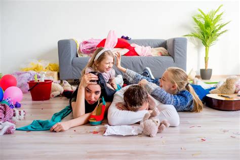 Tired Parents And Romping Kids Stock Image - Image of indoor, mess ...