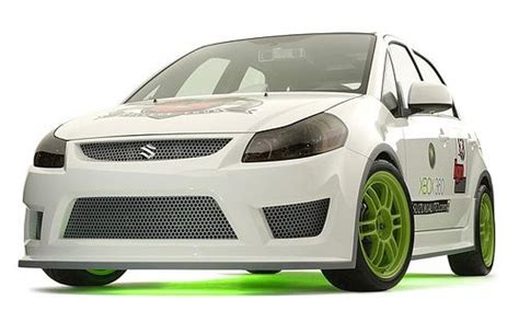 a small white car with bright green rims