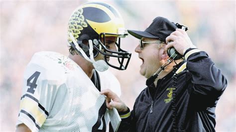 Harbaugh signs UM contract; 'He's been bred for this'