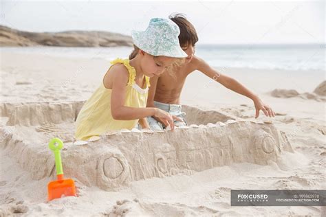 Children making sandcastle on beach — girl, childhood - Stock Photo ...