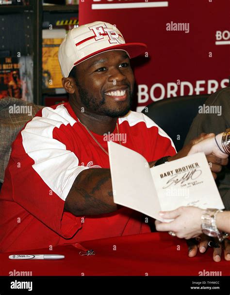 50 Cent signs copies of "Death Before Dishonor", "Baby Brother" and ...