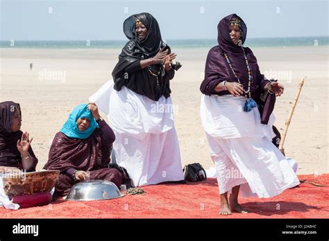 Africa, Western Sahara, Dakhla. Women in traditional dress dancing and ...