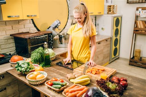 Young woman cooking on recipes, healthy food Stock Photo by NomadSoul1