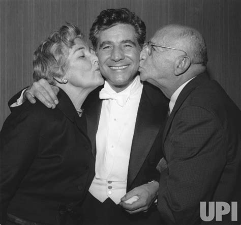 Photo: Leonard Bernstein is kissed by his parents after his first concert as conductor of the N ...