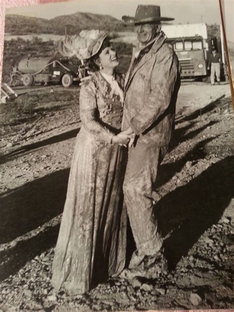 Duke and Maureen O'Hara during the filming of the mud slide scene in "McLintock!" (1963). | John ...