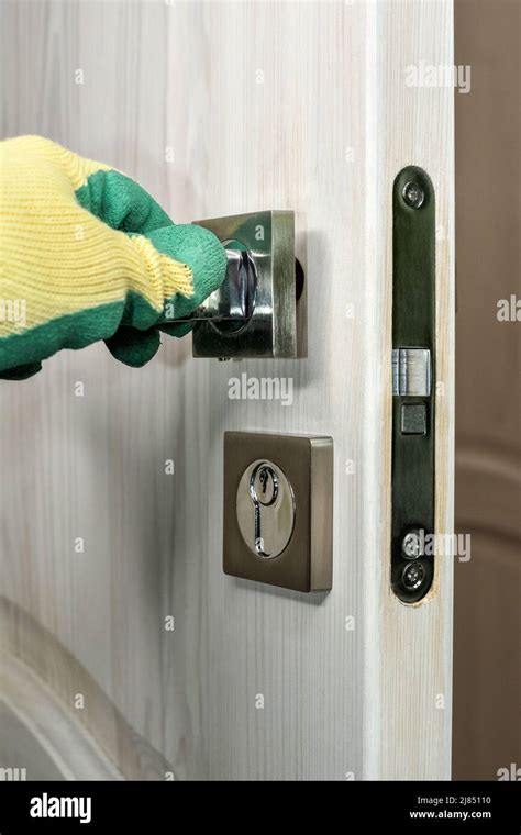 Door handle installation. Lock repairman installing door handle. Repair ...