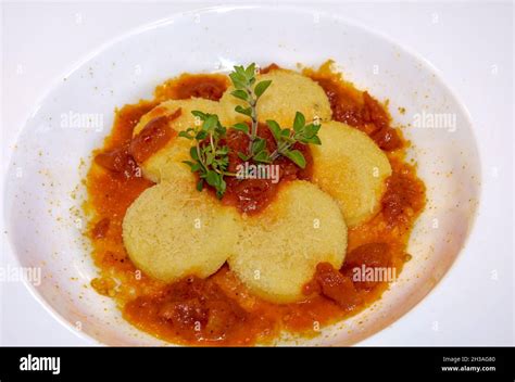 Gnocchi alla Romana with tomato sauce and cheese , typical Italian dumplings of Rome made with ...