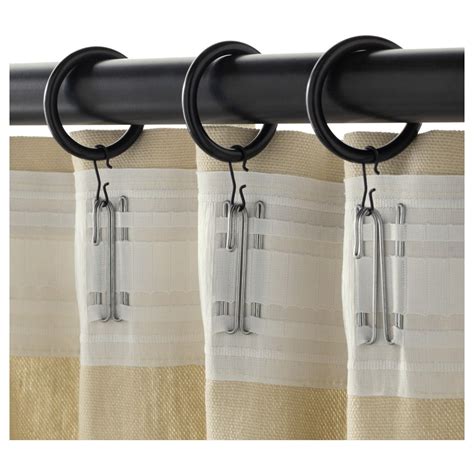 the curtain rod is attached to the side of a window with two rings on it