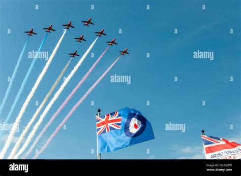 RAF Royal Air Force Red Arrows jet planes flying over RAF ensign flag ...