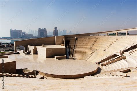 View of modern amphitheatre in Katara Cultural Village in Doha, Qatar with skyscrapers in ...