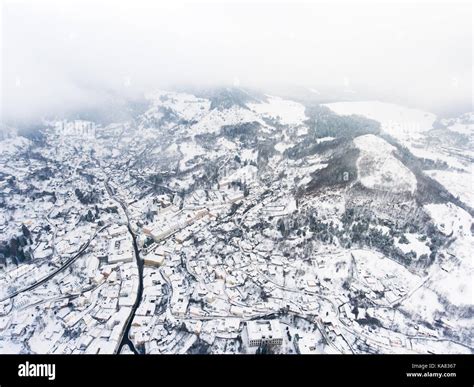 Aerial view of small town with hills in winter Stock Photo - Alamy