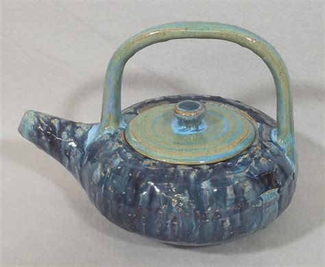 A handmade teapot using three main shapes: round, oval & rectangular