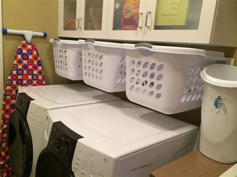 Hanging, slide-out laundry baskets for sorting in a small laundry room ...