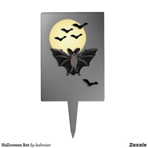 a bat shaped cake topper with bats flying around it on a white background for halloween