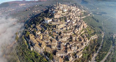 Aerial view of ancient San Marino city on lush hill · Free Stock Photo