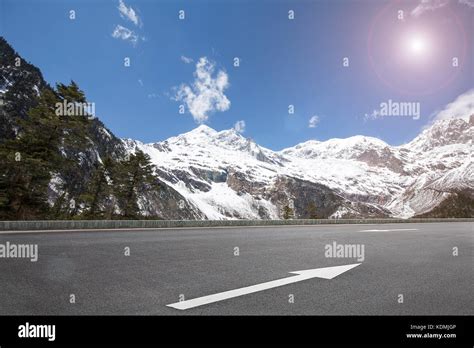 Snow mountain with highway Stock Photo - Alamy