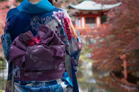 Young girl wearing Japanese kimono standing in front of Temple in Kyoto ...