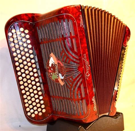 an old red accordion sitting on top of a table