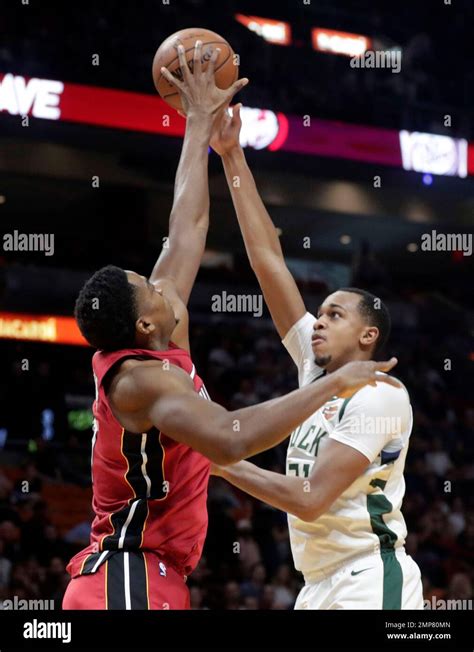 Miami Heat's Hassan Whiteside, left, blocks a shot by Milwaukee Bucks ...