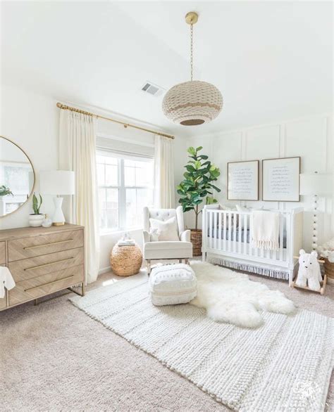 Beautiful gender neutral nursery design with white walls and woodland decor - soft, modern, and ...