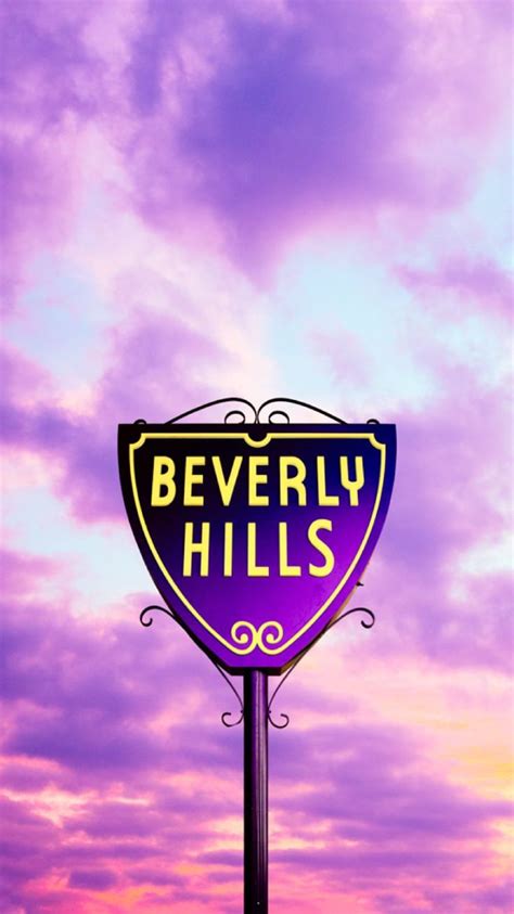 a purple and yellow sign that says beverly hills in front of a cloudy ...