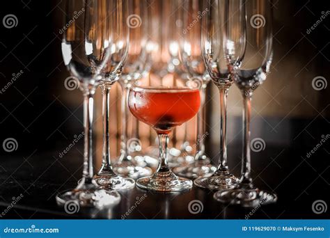 Glass Filled with Tasty Red Summer Alcoholic Drink with Empty Champagne ...