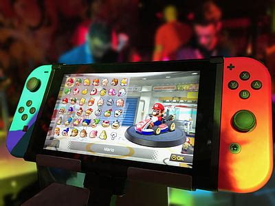 Royalty-Free photo: Turned on Nintendo Switch with Joy-Con and Super Mario game display | PickPik
