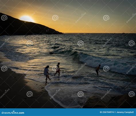 People on Beach at Sunset stock photo. Image of scene - 256704974