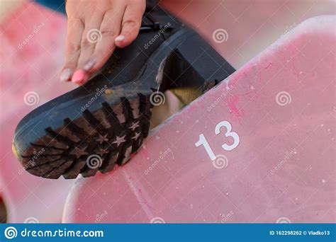 Woman Wiping Her Boots on a Stadium Seat Stock Photo - Image of pose, emancipated: 162298262