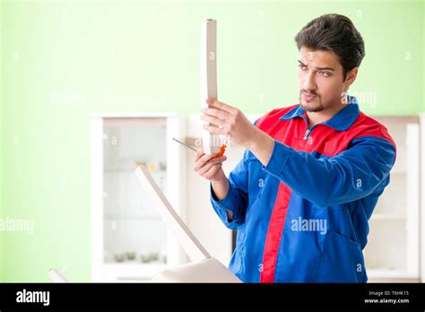 Repair contractor repairing broken chair at home Stock Photo - Alamy