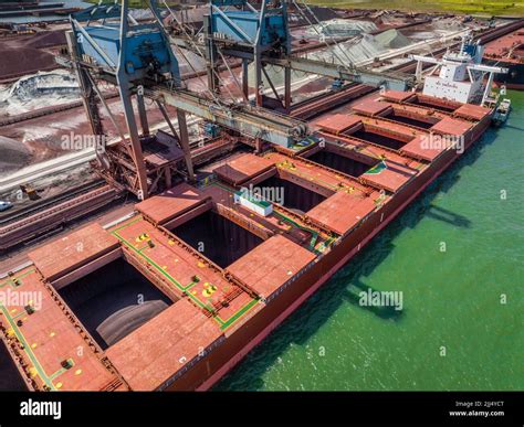 Bulk Carrier Ship Unloading Cargo by Crane at Port Stock Photo - Alamy