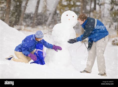 Building a snowman Stock Photo - Alamy