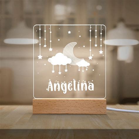 an acrylic light with the word angelina on it and stars in the sky