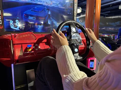 Woman Driving a Racing Game. Girl on a Racing Car Simulator. Concept: Computer Games, Car Racing ...