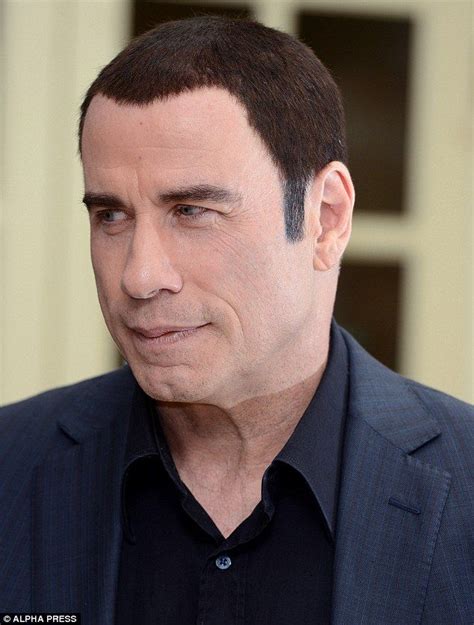 You should have kept your hat on: John Travolta shows off bizarre two-tone hairstyle at Savages ...