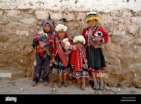 Inca children carrying pets in Pisac, Peru, South America Stock Photo - Alamy