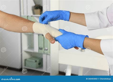 Doctor Applying Medical Bandage Onto Patient`s Hand in Hospital, Closeup Stock Photo - Image of ...