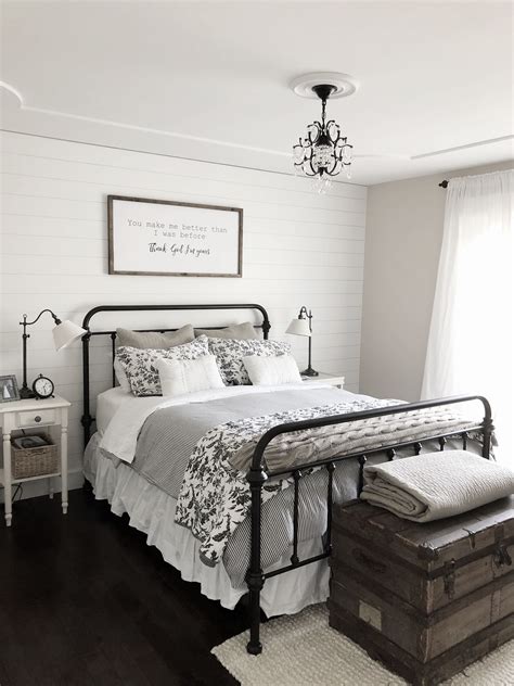 Modern farmhouse bedroom decor shiplap accent wall, black iron bed, vintage blanket storage ...