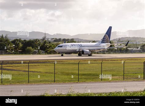 United Airlines Boeing 737-724 Airplane departing V. C. Bird International Airport, St. John's ...