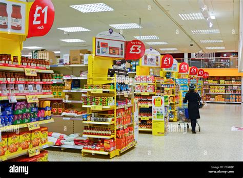 Tesco supermarket interior with display stands flagged with red offer ...