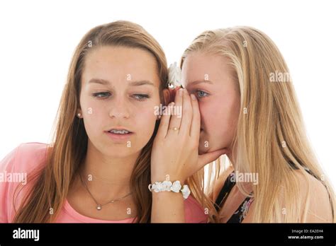 Teen girls are whispering gossip to each other Stock Photo - Alamy