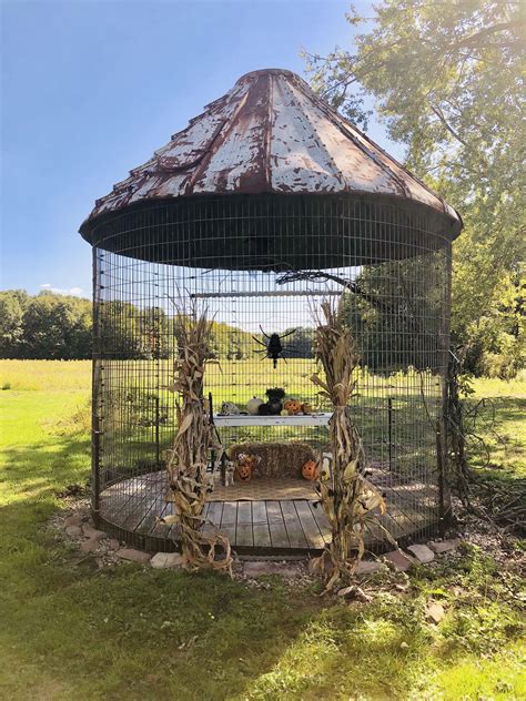 an outdoor gazebo in the middle of a field with corn stalks growing out ...