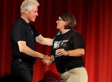 Clinton initiative volunteers paint, plant, lay carpet at St. Louis magnet school