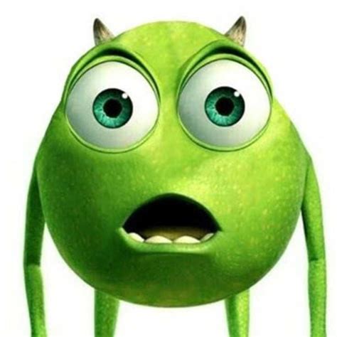 a green monster with big eyes and horns on it's head is looking at the camera