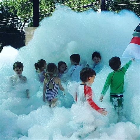 Kids line up to play in the foam machine bubbles. The foam powder packs ...