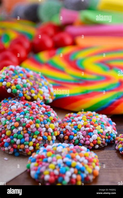 Bright rainbow lollipop candy on dark wood table Stock Photo - Alamy