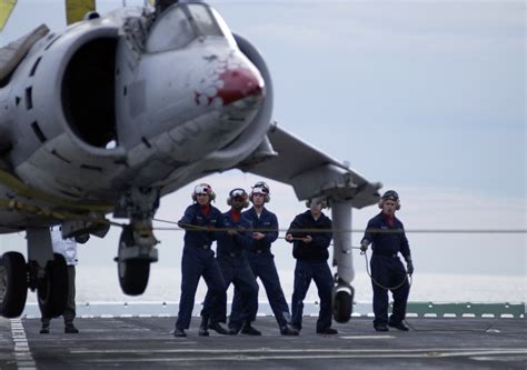 File:US Navy 050217-N-9866B-001 Aviation Boatswain's Mates work together to provide guidance to ...