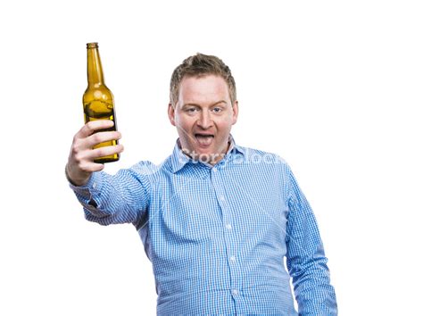 Humorous young man with a beverage. Studio shot on white background ...